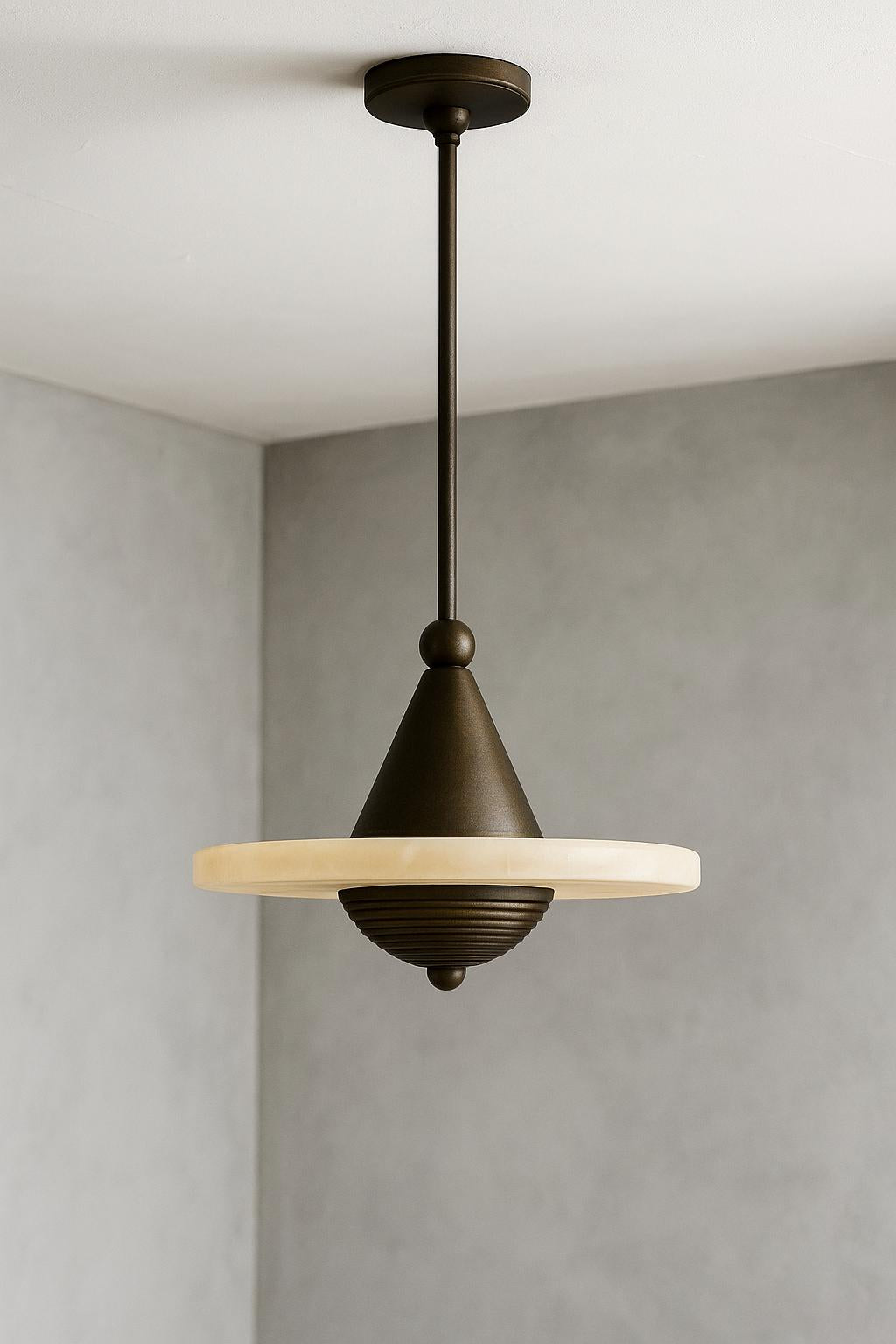 Bronze cone pendant with off-white stone disc on rod